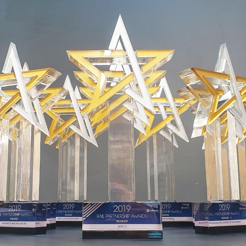 Multi-layered acrylic award for Rail Partnership winners – gold and white star design with printed base plaque