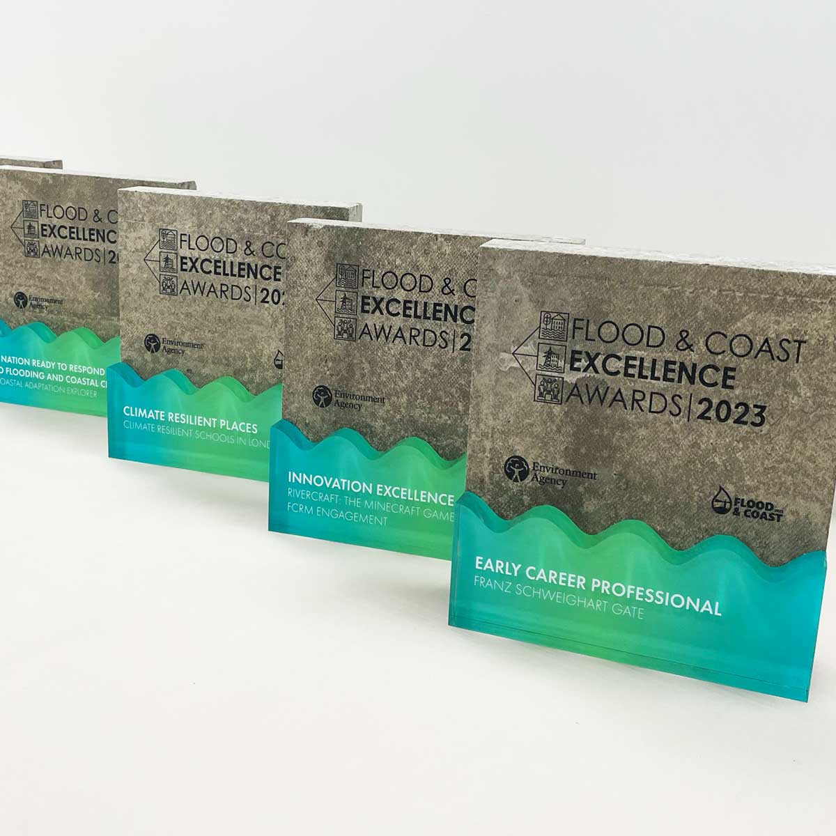 Flood & Coast Excellence Award made from cast concrete with engraved text and wave-shaped recycled acrylic detail