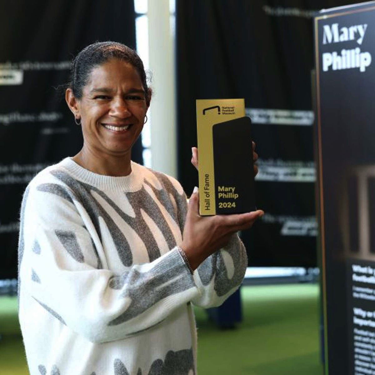 Mary Phillip receiving bespoke award by More Awards for National Football Museum