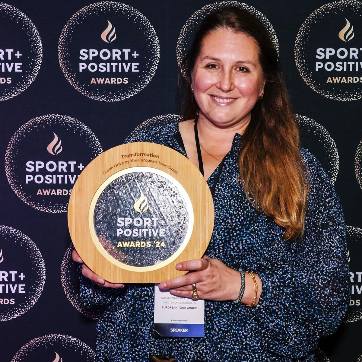 Maria Grandinetti holding bespoke bamboo and recycled acrylic award for Sport Positive Awards 2024 – Green Drive by European Tour Group