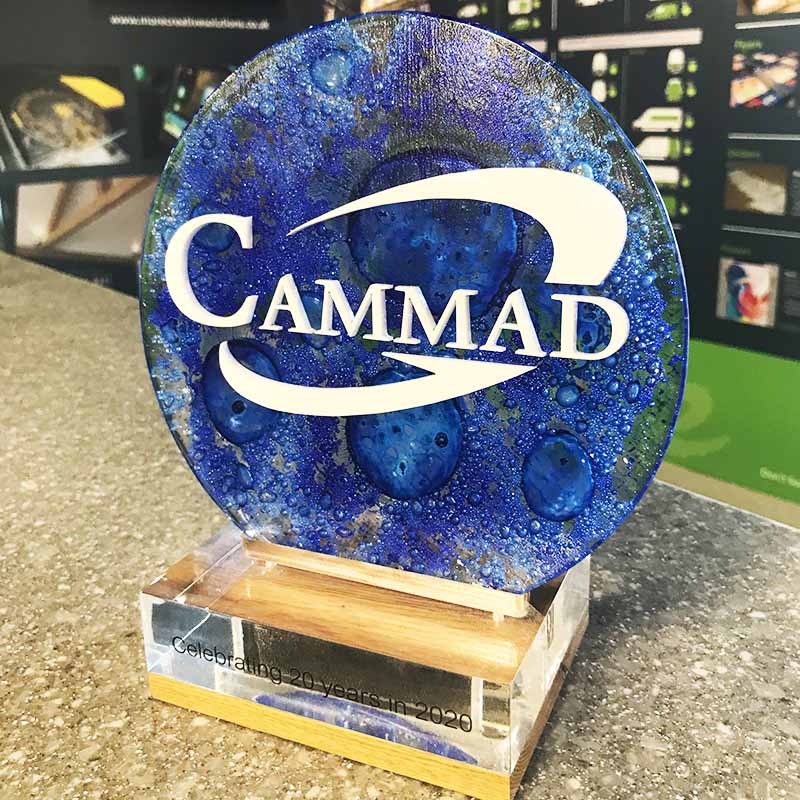 CAMMAD anniversary trophy with blue recycled glass disc on clear acrylic and bamboo base – sustainable milestone award