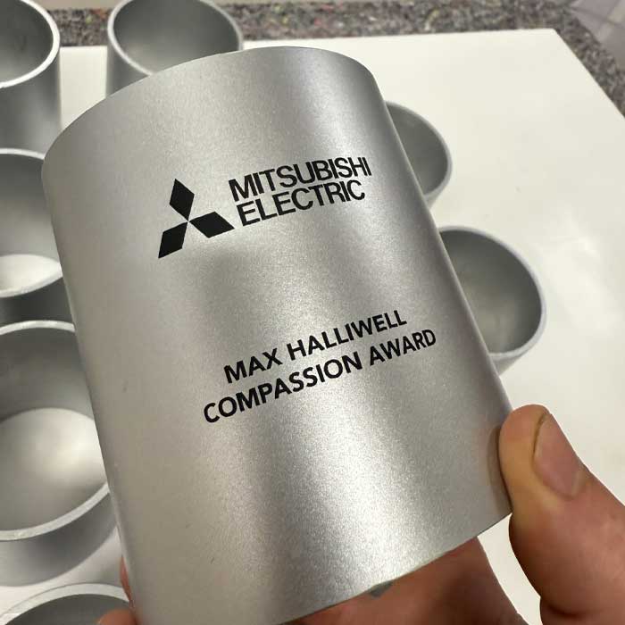 Laser engraved tube with Mitsubishi logo for bespoke award | More Awards