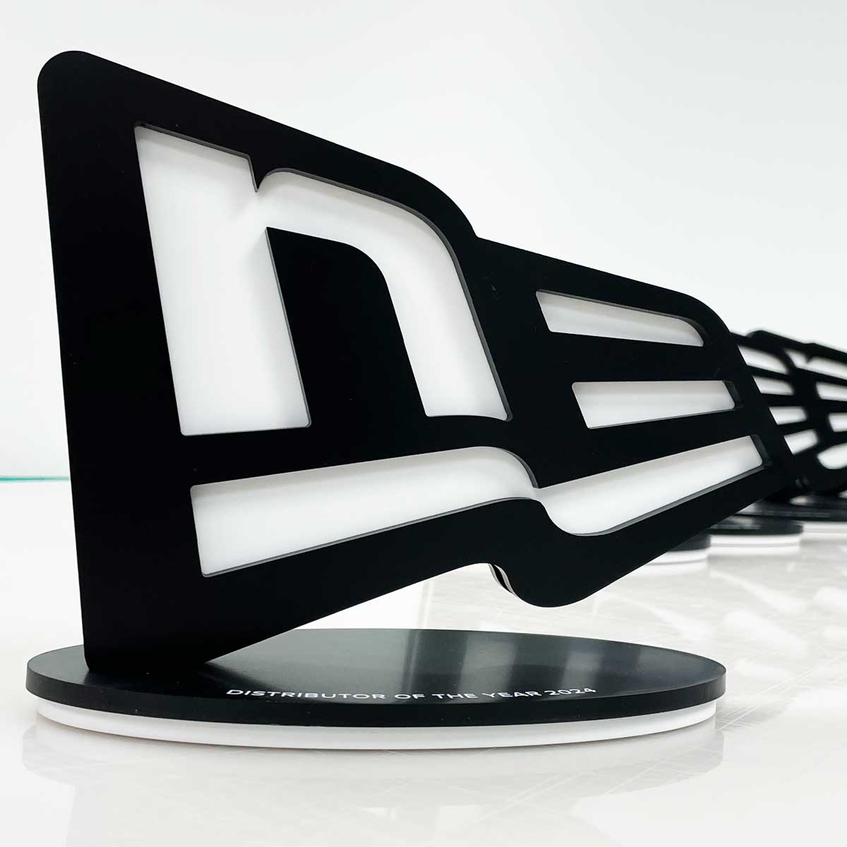 Eco Stone trophy for New Era – logo-shaped award with engraved base for Distributor of the Year 2024
