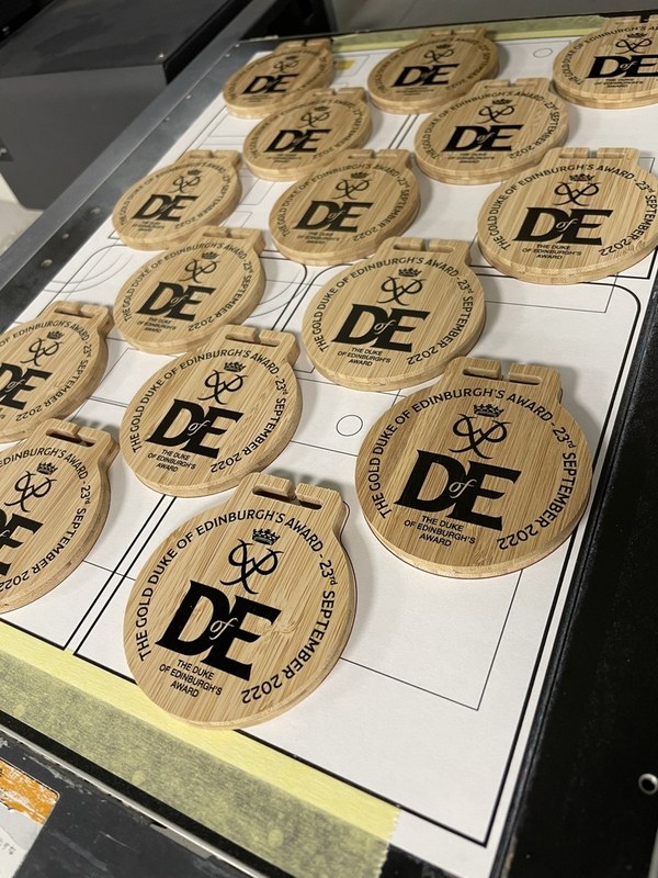A batch of Duke of Edinburgh bamboo medals on the production bed before ribbons are fitted