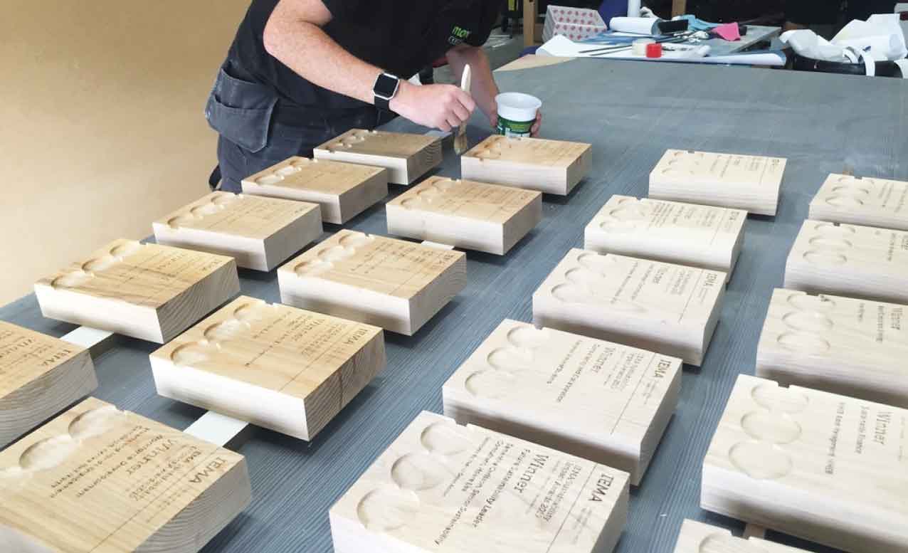 Finishing bespoke wooden awards in the More Awards workshop