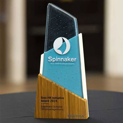 Sustainable Aswen Award being presented on stage, crafted from recycled glass with a bamboo base