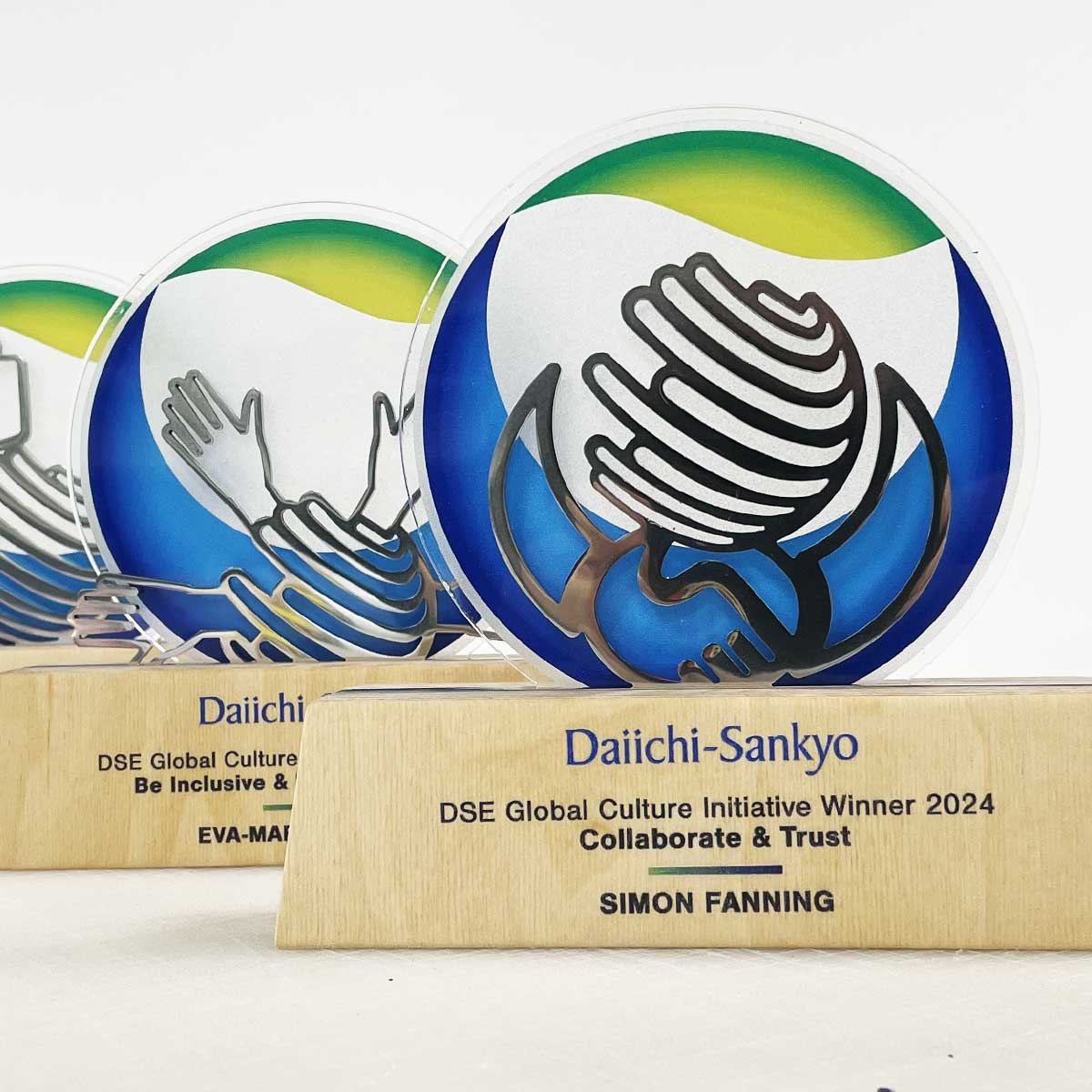 Dorn birch-based award topped with a precision-cut stainless steel logo, made by More Awards for company milestones and bespoke recognition events