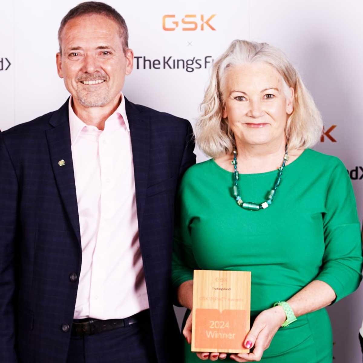 Company representatives accepting an engraved Eseld wooden trophy by More Awards during a corporate event honouring service excellence