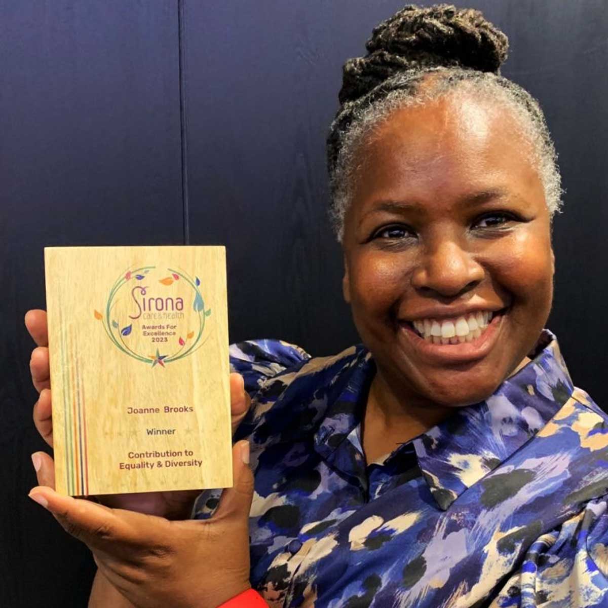 Staff members awarded a printed Eseld wooden block trophy by More Awards at a business recognition and staff appreciation event