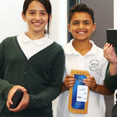 Student receiving bamboo frame award at school