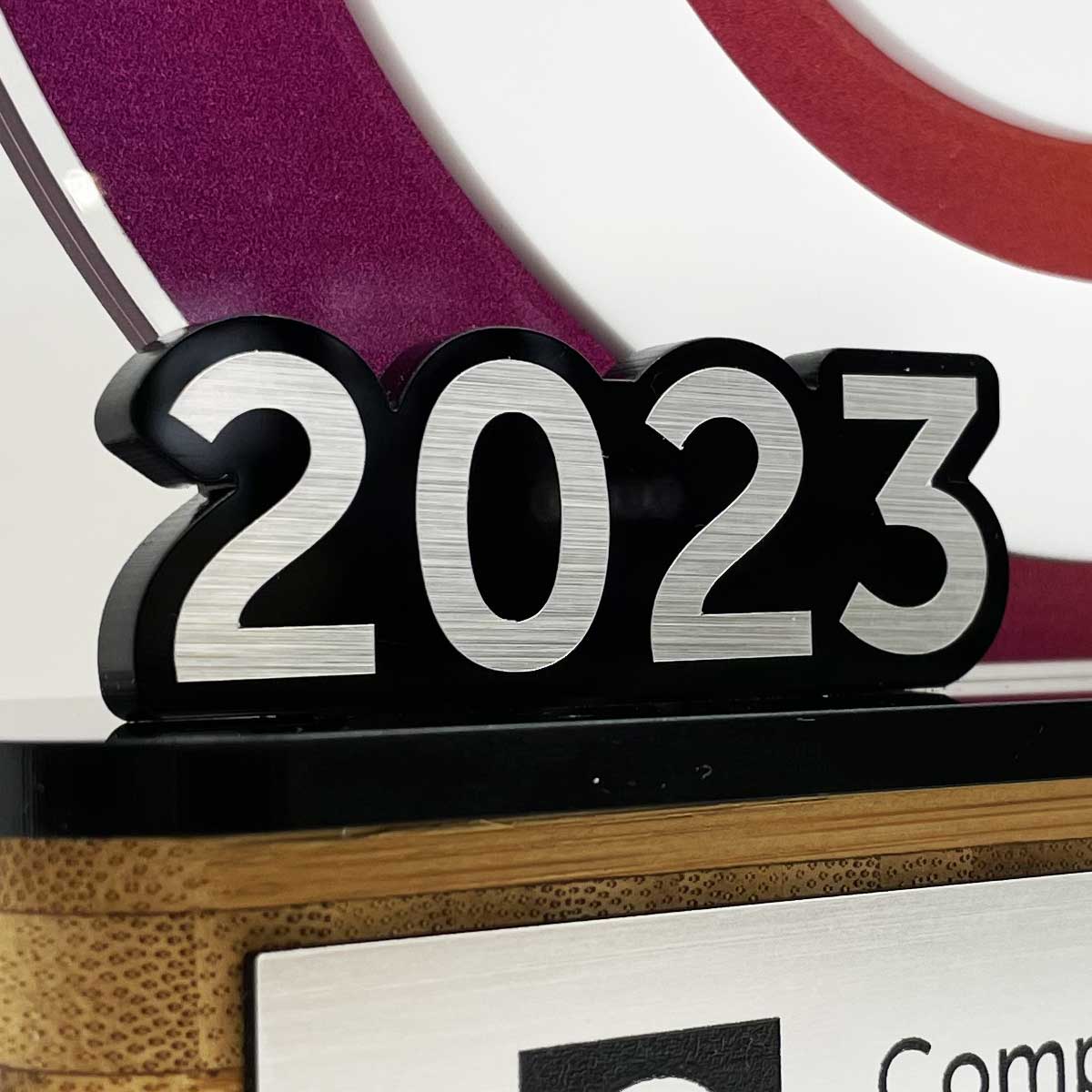 Circular acrylic trophy with 3D date detail, created by More Awards for arts, culture, and creative industry recognition