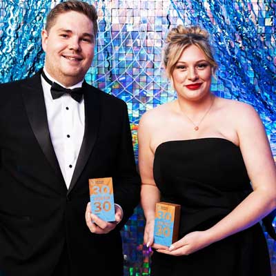 Proud winner holding the eco-friendly Lowdy wooden block awards