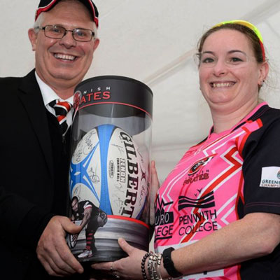 Recipient accepting the Dorn Award made from recycledacrylic and bamboo during a live ceremony 