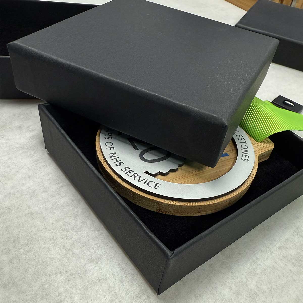 Presentation of running medals with boxes and branding