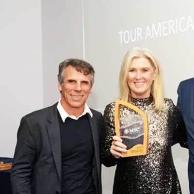 Sustainable Aswen Award being presented on stage, crafted from recycled glass with a bamboo base