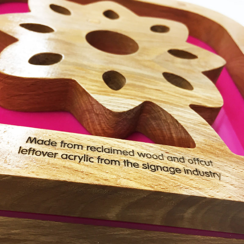 Reclaimed timber awards cut into flower shape with pink backing detail by More Awards