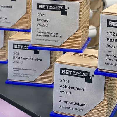 Birch ply eco awards in a cube shape with folded aluminium plate on side by More Awards